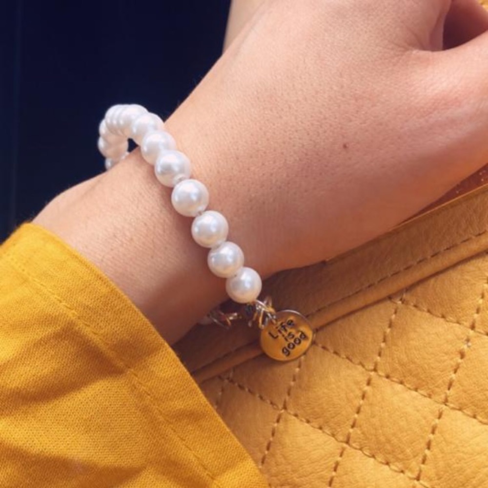 Pearl bracelet with a “life is good” chain pendant